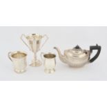 Silver items, comprising a small half reeded teapot with ebonised handle and knob.