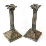 Pair of George V silver Corinthian column candlesticks on stepped square bases, by Walker & Hall,