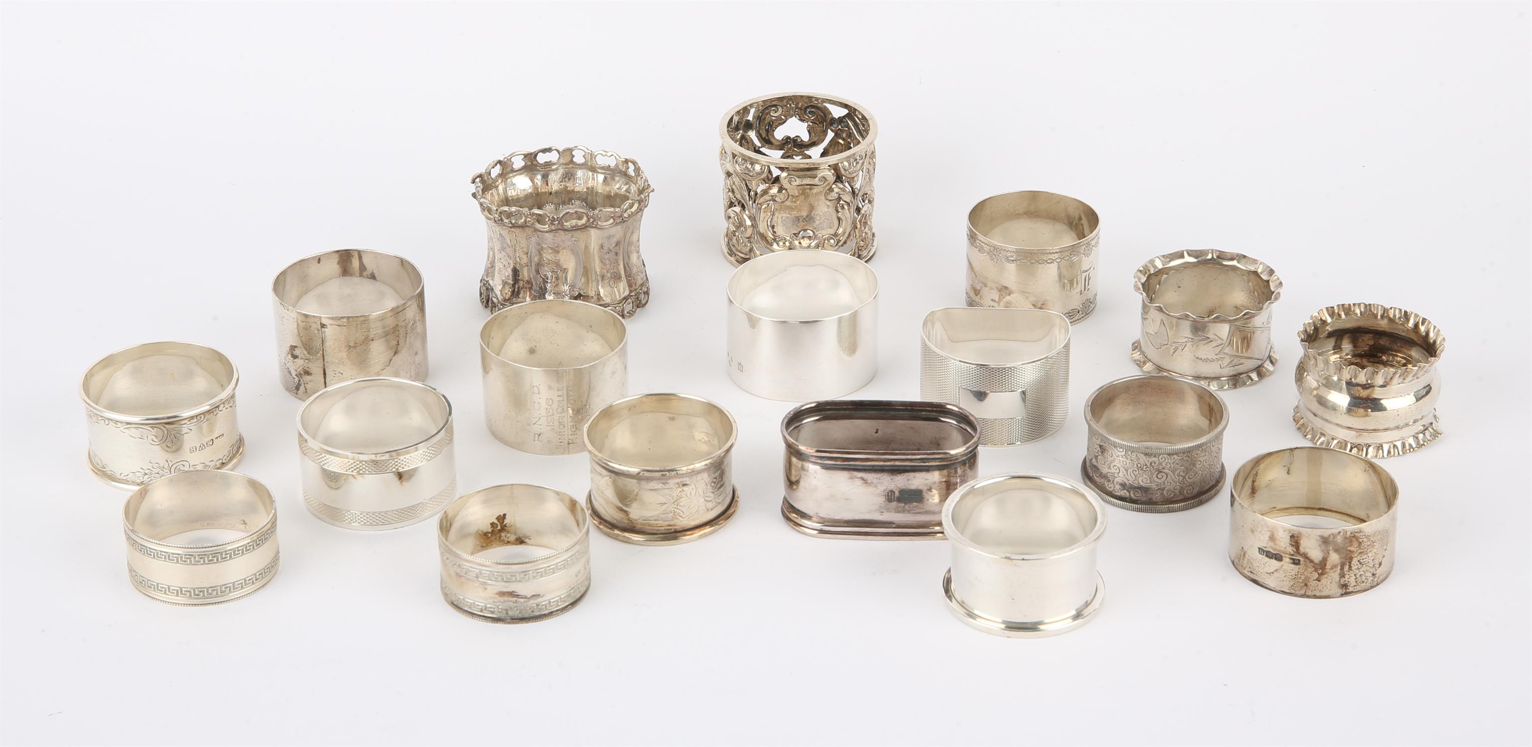 Eighteen various Victorian and later silver napkin rings, in a walnut box, 14.1 ozs,