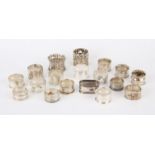 Eighteen various Victorian and later silver napkin rings, in a walnut box, 14.1 ozs,
