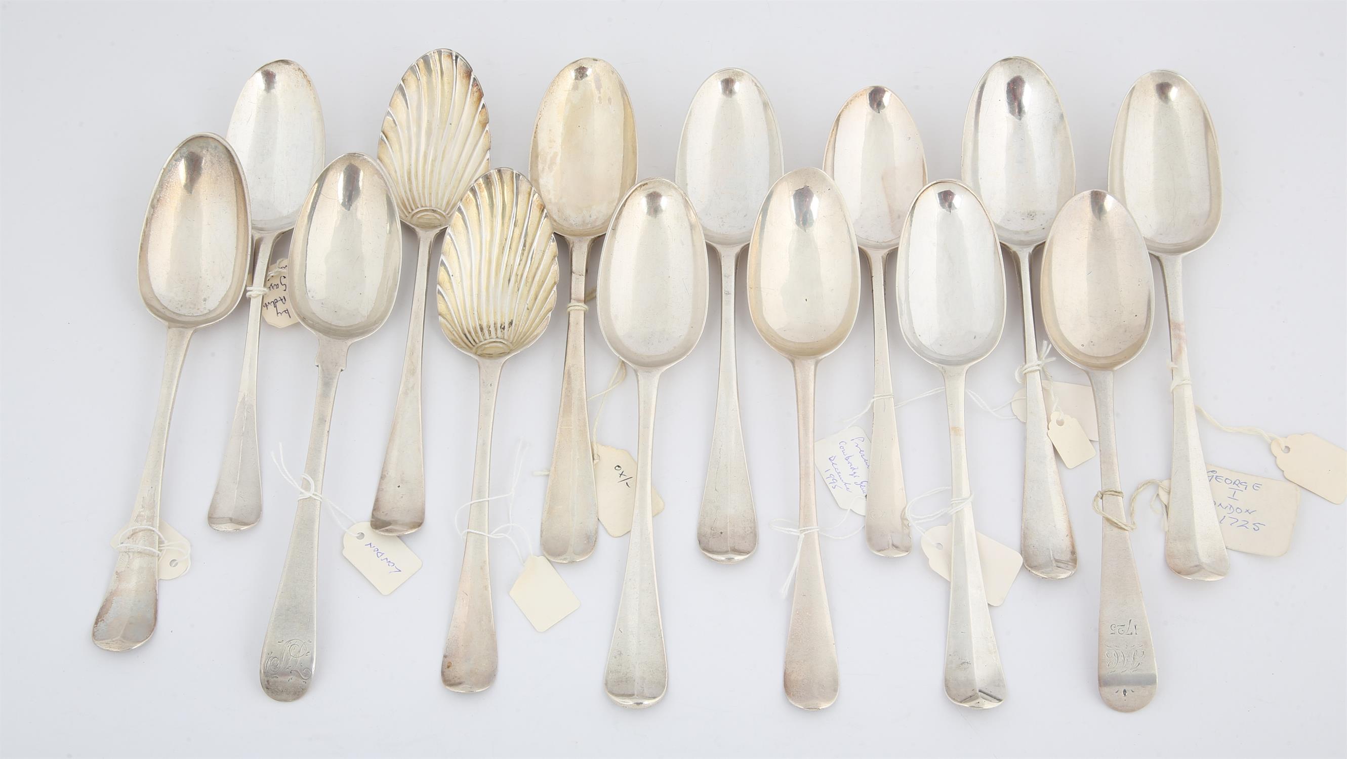 Fourteen various 18 century English table spoons including two with shell bowls, 24.