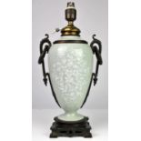 Bronze and celadon glazed pottery oil lamp base, 19th Century, decorated with white pate -sur-pate