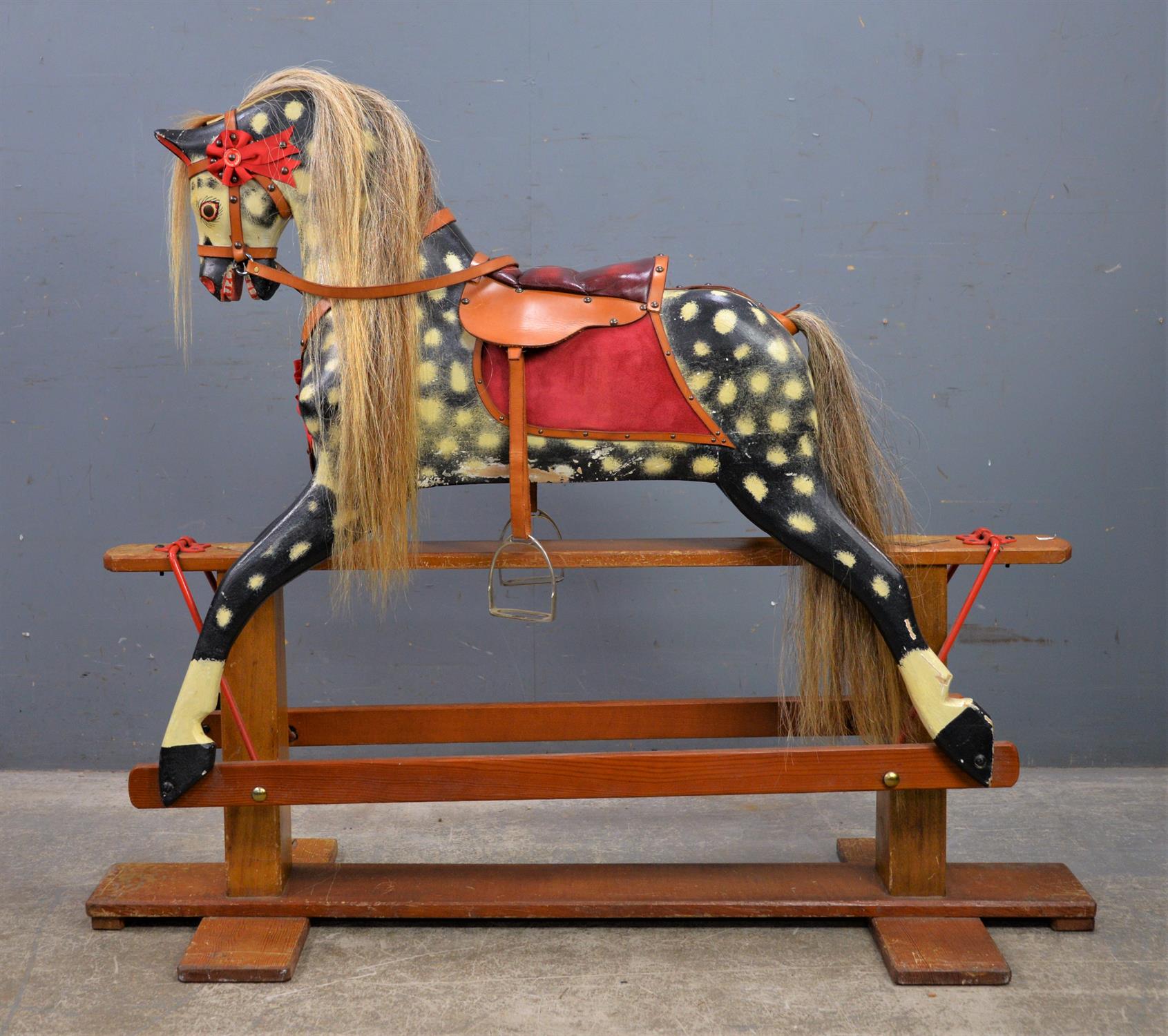 Children's dappled grey rocking horse, 20th Century, with a leather saddle and stirrups,