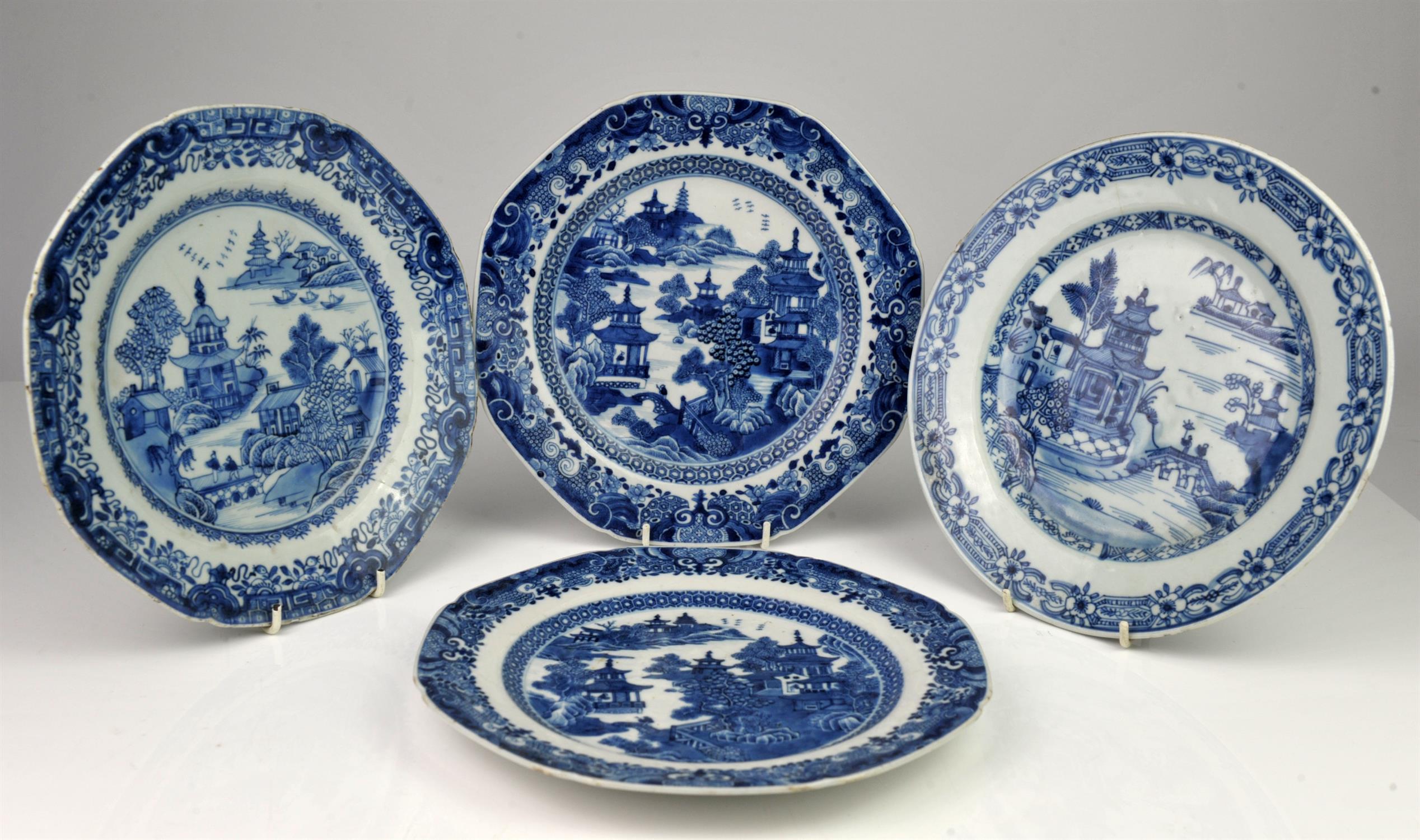 Four Chinese blue and white plates with patterned borders and decorated with figures on a bridge