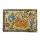 Persian Qajar polychrome tile depicting a man playing a musical instrument amongst flowers,