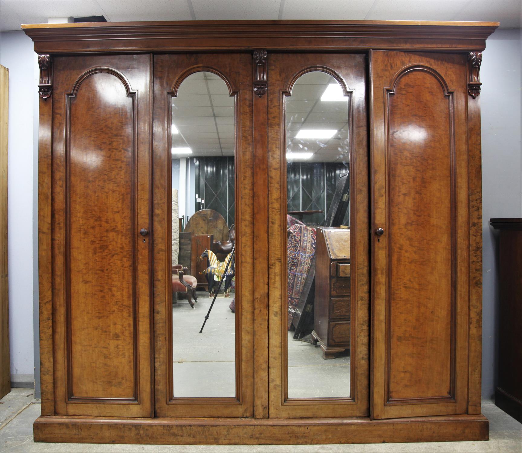 A Victorian Mahogany veneered Wardrobe/Compactum, Cornice over four doors, the central two doors