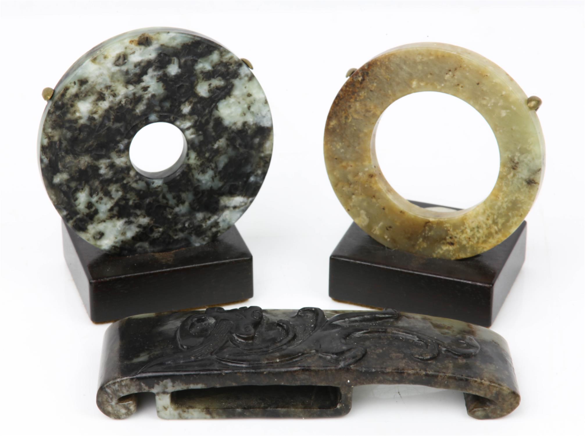 Chinese jade mottled black and grey bi-disc, one side carved with scrolling decoration,