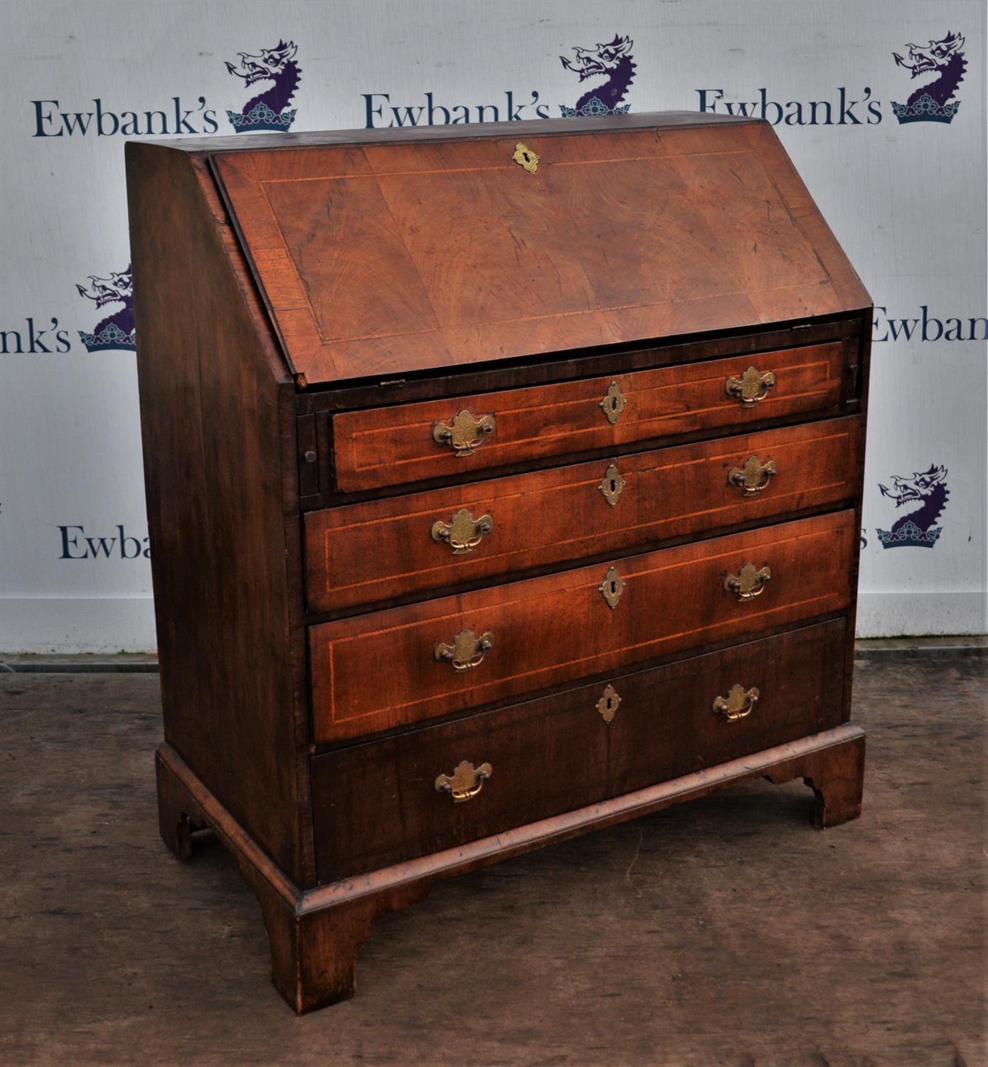 George III walnut bureau, with fall flap enclosing an arrangement of cupboards and pigeon holes,