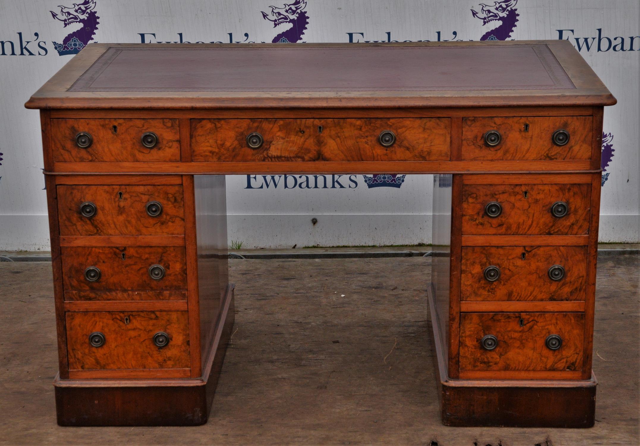Victorian walnut pedestal desk, the top with red inset leather surface, above three frieze drawers,
