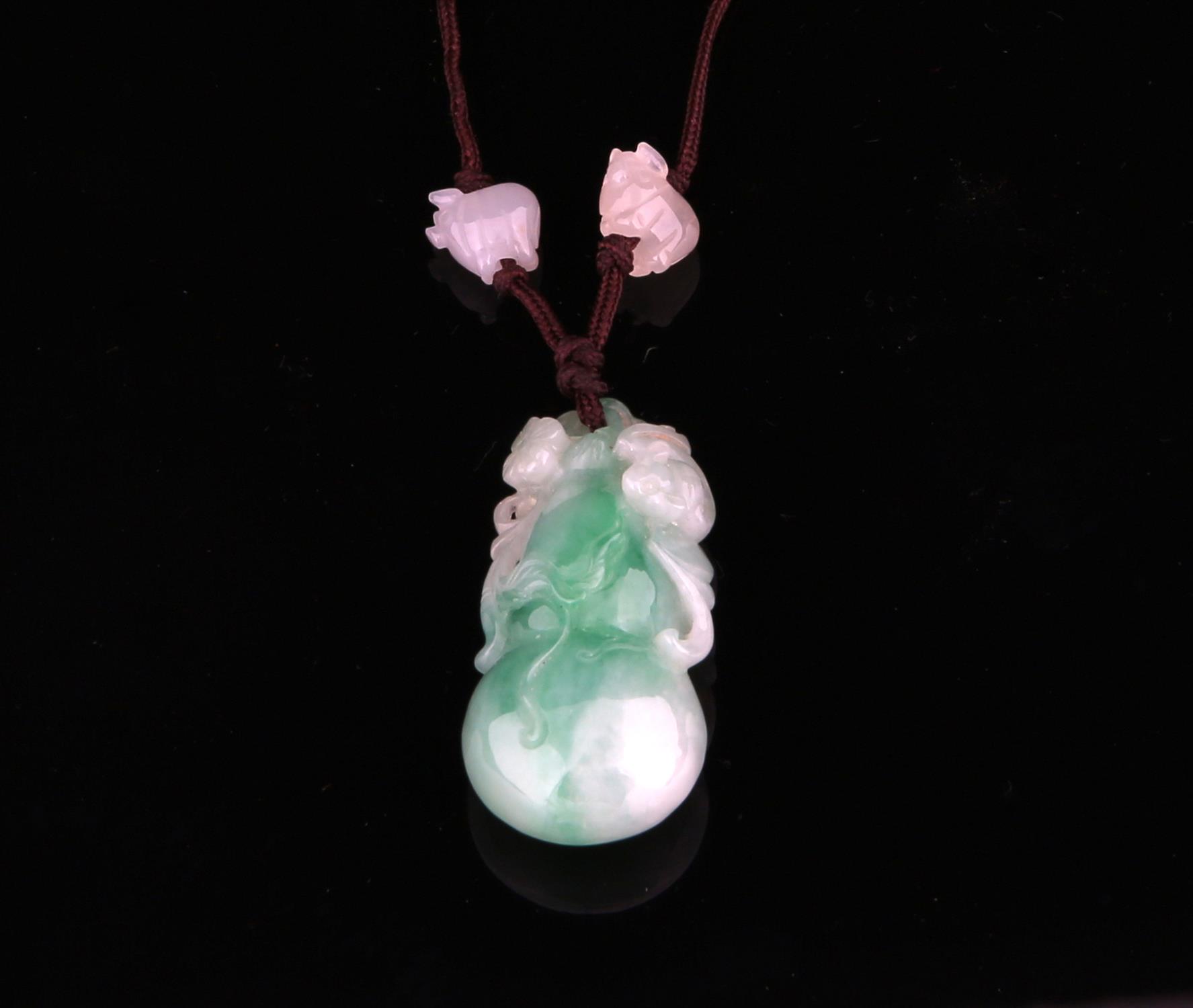 Chinese mottled green jade pendant in the form of a double gourd and a single bat and flowers and