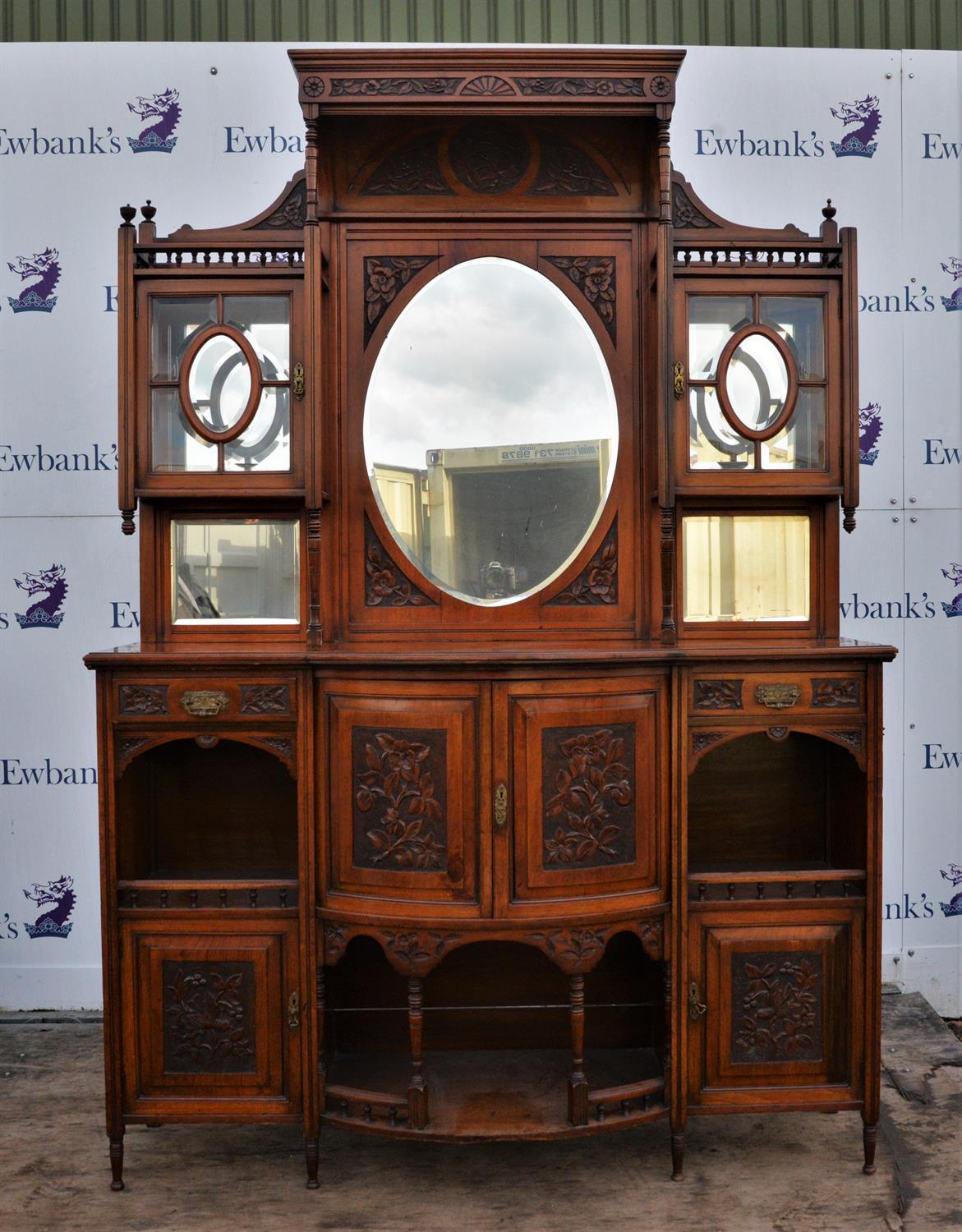 Edwardian mahogany dresser, with ornate carved superstructure, oval mirror flanked by cupboards,