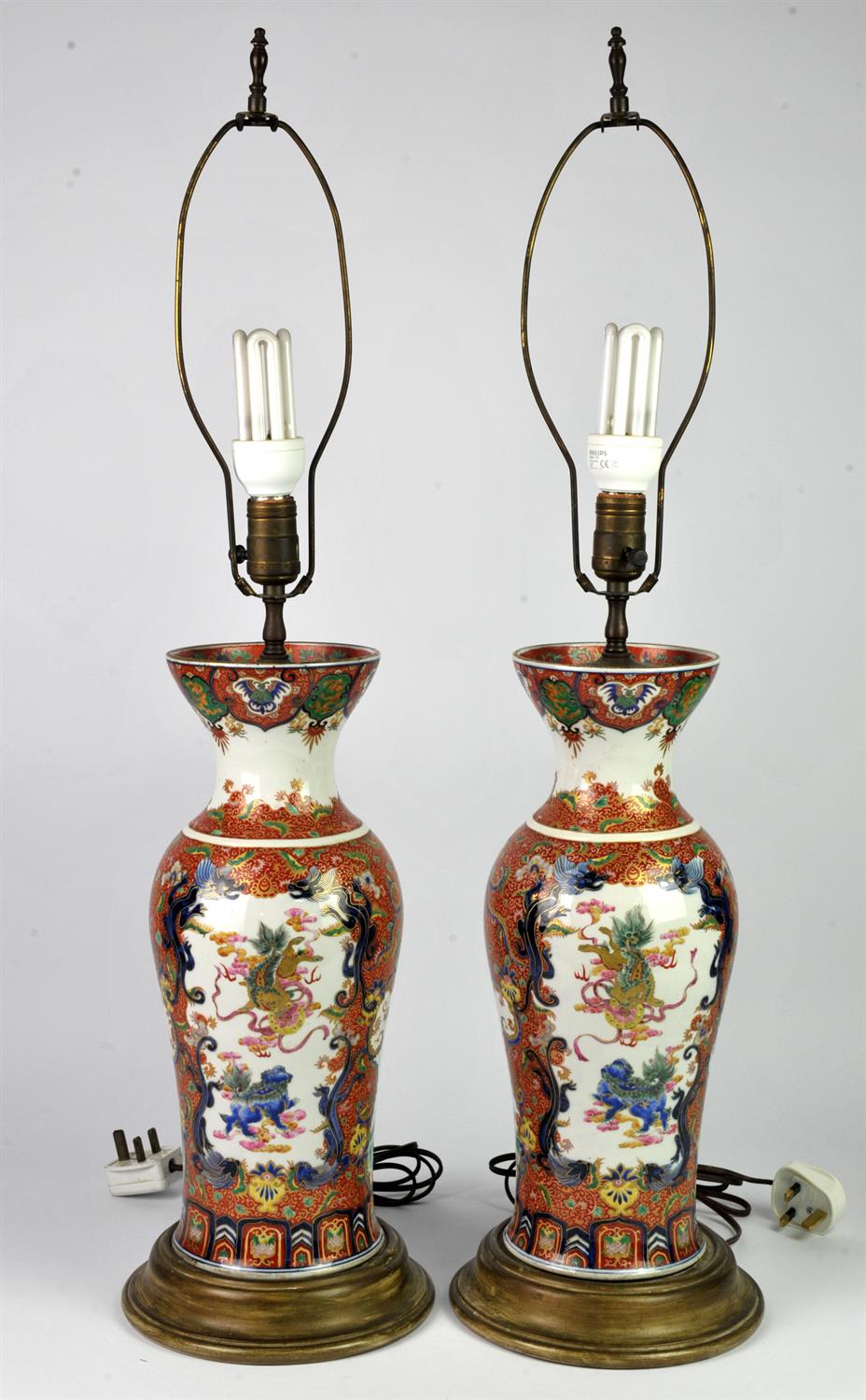 Pair of Chinese vases painted and enamelled with panels of a dragon flying above the ocean and