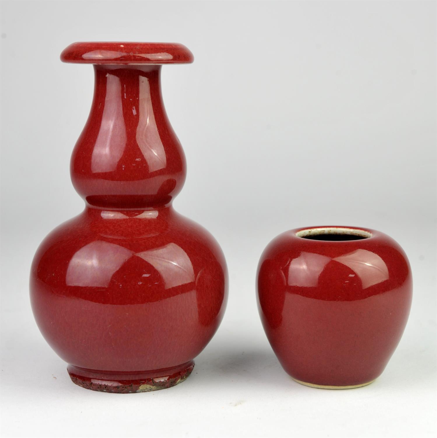 Chinese Ox blood double gourd vase with flared rim 16.5cm high, and a ovoid brush pot 7.5cm high,