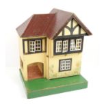 Tri-Ang mock Tudor style dolls house with car porch, label verso, h43 x w35 x d27.