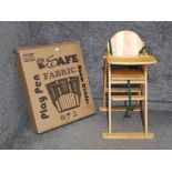 A play pen (boxed) and a wooden high chair