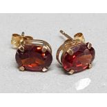 Pair of 9ct yellow gold & red stone earrings, 1g gross