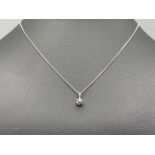 8k white gold and diamond pendant with chain.