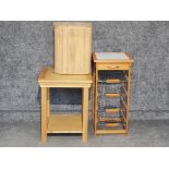 Tile topped kitchen storage unit together with light oak side tabel and wooden laundry bin