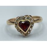 Ladies 9ct gold red stone and CZ heart shaped ring.