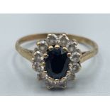Ladies 9ct gold cluster ring with black centre stone and cluster of CZs. Size P 2.2g