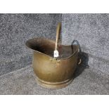 A brass helmet shaped coal scuttle