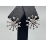 Silver and CZ snowflake stud earrings.