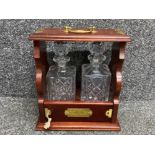 Mahogany tantalas plus a pair of crystal glass decanters, with original key