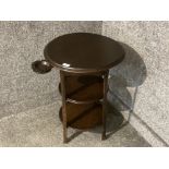 A three tier circular table with Rayrolle Bakelite ashtray that folds in