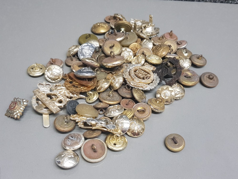 Collection of various military badges and buttons