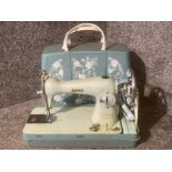 A vintage Jones sewing machine with hard plastic case