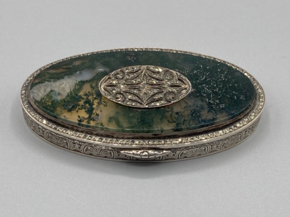 A silver oval snuff box with moss agate and marcasite decoration to cover, gilt interior 69.6g