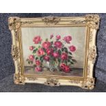 An oil painting of roses in a vase indistinctly signed 38 x 48cm