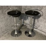 A pair of contemporary metal and leatherette bar stools