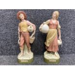 A pair of Royal Dux water carriers 39cm high