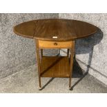 An Edwardian inlaid mahogany drop leaf hall table with under tier