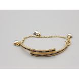 Child's 18ct yellow gold blue and white stone ornate bracelet with three charms in the form of
