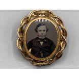 A Victorian yellow metal brooch with a photographic portrait of a man 37.1g gross