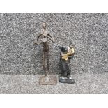 A bronze figurine of a saxophone player plus a resin one