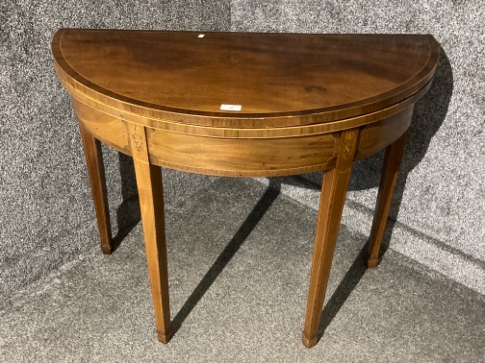 An Edwardian inlaid mahogany fold over tea table