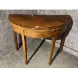 An Edwardian inlaid mahogany fold over tea table