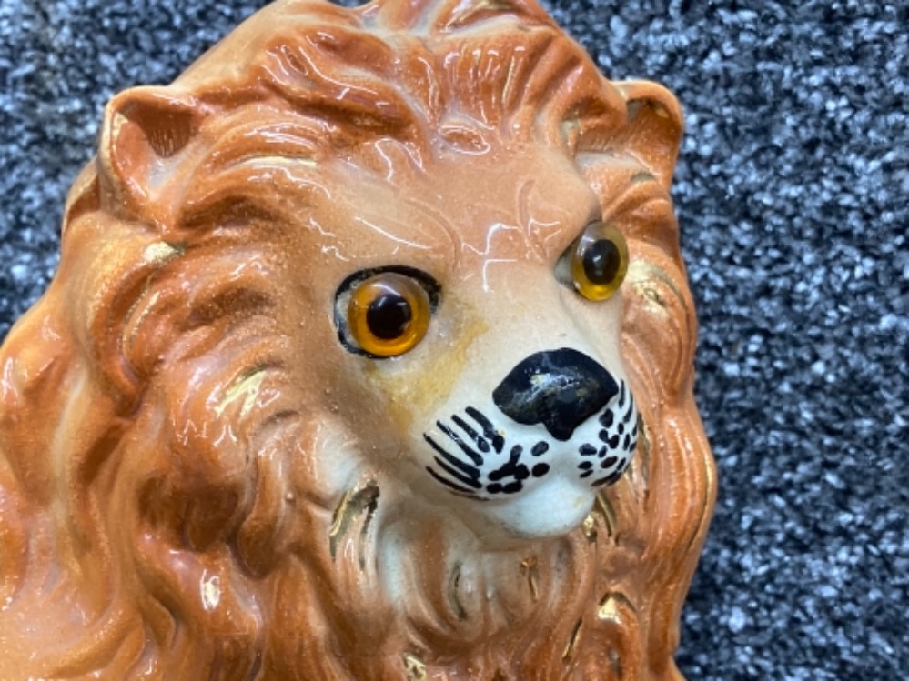 A pair of Staffordshire lions with glass eyes 25cm high - Image 2 of 3