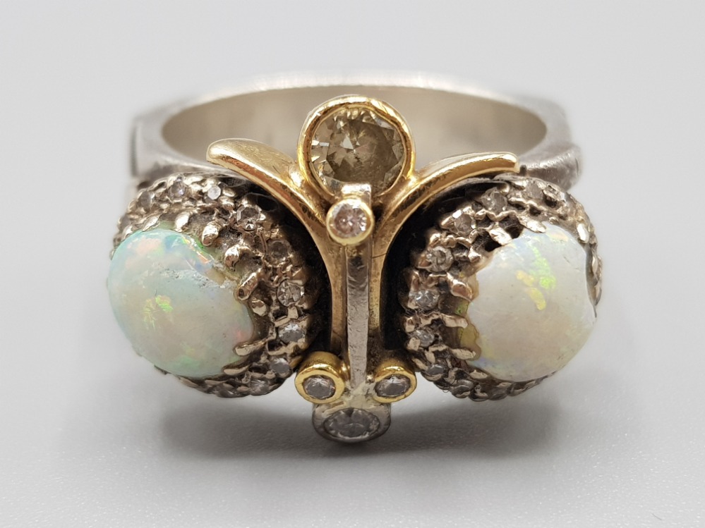 Silver and gold opal and diamond ornate ring, with two opals surrounded by diamonds and five