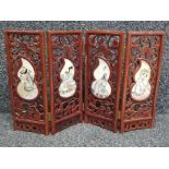 Small heavily carved hardwood folding screen - oriental style with 4 handpainted panels