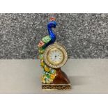 A miniature enamel clock with a perching peacock 11cm