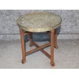 Circular brass topped eastern style Occasional table on folding wooden base