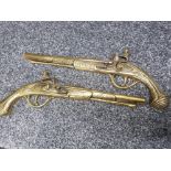 Pair of brass ornamental wall plaques in the form of flintlock pistols