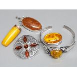 Amber costume jewellery including small pill box, bangle, pendant & brooch also includes a cheroot