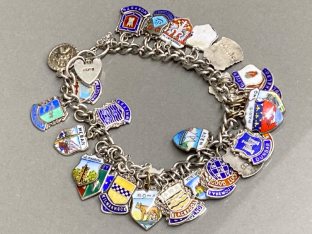 Silver padlock charm bracelet with approximately 35 charms, 59.3G