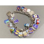 Silver padlock charm bracelet with approximately 35 charms, 59.3G