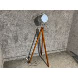 Electric chrome spotlight on wooden tripod stand